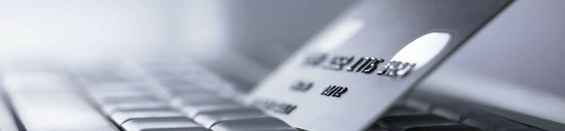 credit card on laptop keyboard credit card on laptop keyboard